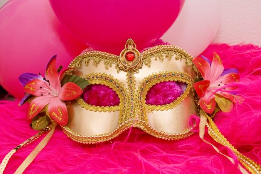 golden mask with flowers and pink fluffy fur and balloons