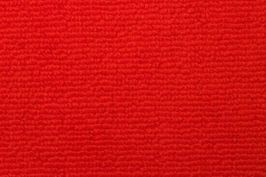 Close-up of an red indoor warm and soft carpet.