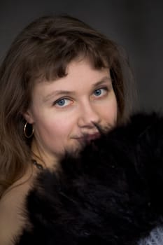 Portrait of the girl with a fan in hand