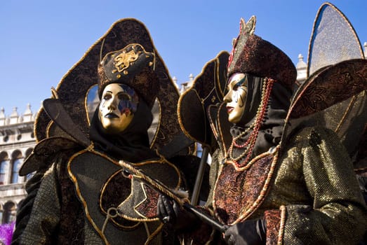 Traditionally dressed Venice carnival couples in Piazza San Marco, Italy
