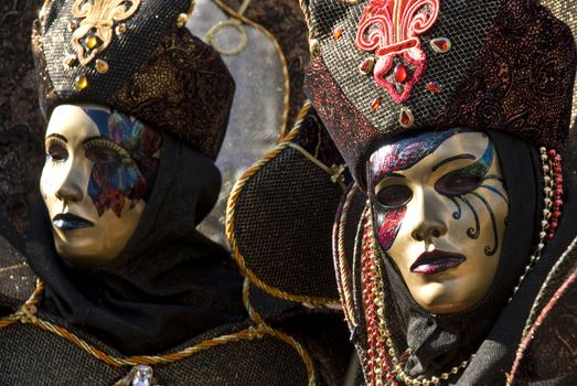 Traditionally dressed Venice carnival couples in Piazza San Marco, Italy