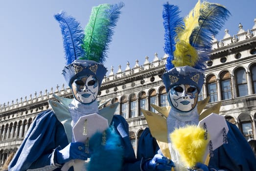 Traditionally dressed Venice carnival couples in Piazza San Marco, Italy
