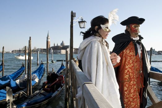 Traditionally dressed Venice carnival couples in Piazza San Marco, Italy