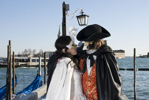 Traditionally dressed Venice carnival couples in Piazza San Marco, Italy