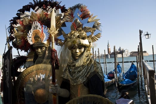 Traditionally dressed Venice carnival couples in Piazza San Marco, Italy
