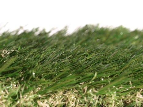 Detail of green grass artificial lawn meadow, useful as a background