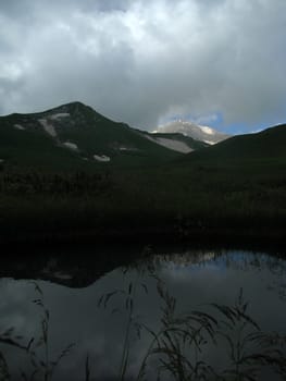 Mountains, rocks; a relief; a landscape; a hill; a panorama; Caucasus; top; lake, water, reflection, a slope; a snow