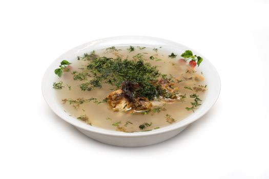 Plate of soup, meat, verdure insulated on white background