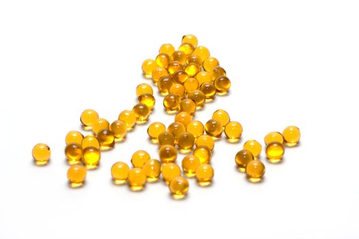 Disposit of the capsules cod-liver oil insulated on white background 