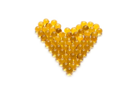 Disposit of the capsules cod-liver oil insulated on white background 