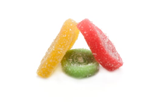 Colour fruit jellies in sugar on white background