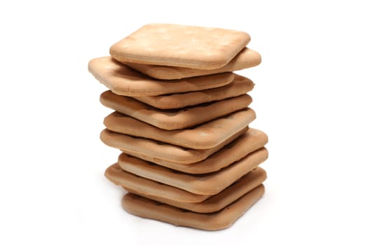 Crackers put by pile on white background