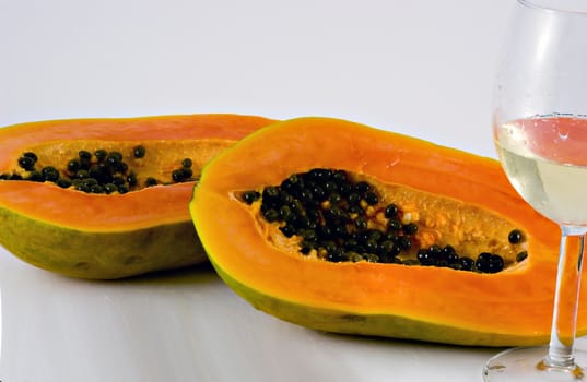 Isolated shot of a papaya being cut  and wine glass