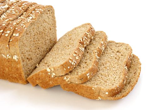 A loaf of honey and oats bread isolated on white.