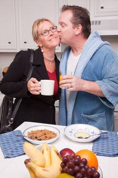 Businesswoman Ready for Work with Husband In Kitchen.