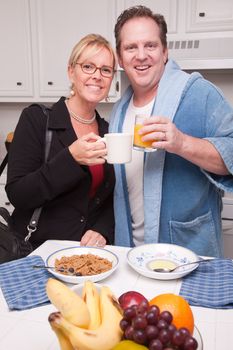 Businesswoman Ready for Work with Husband In Kitchen.