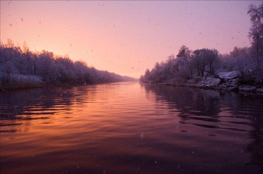 Pink dawn and late snow nearby Ladoga lake in the beginning of May