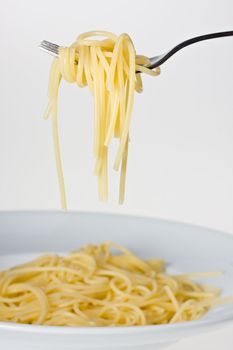 fork over a plate with spaghetti