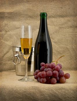 Still-life with a glass of wine and a champagne bottle