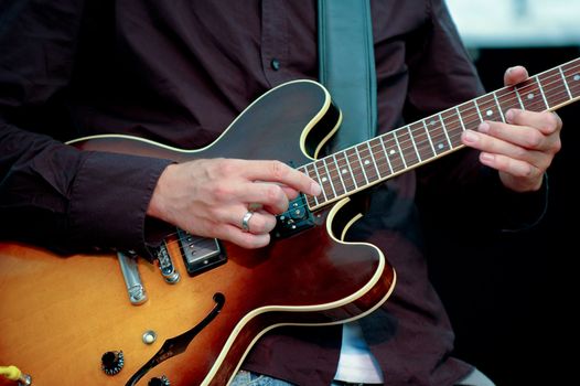 A man is playing his guitar.