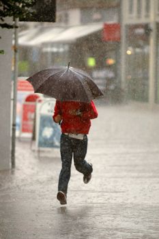 Man running in the rain. Motion blur.