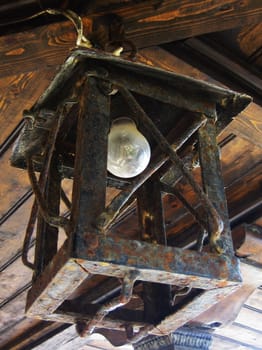 An old rusty lantern with electrical lamp