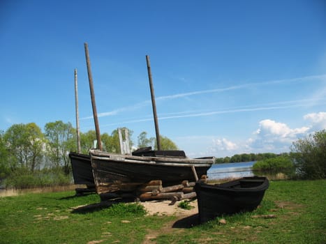 Ancient fishermens boats on the lake coast Novgorod Russia
