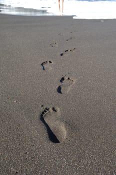 Footprints leading to the sea.