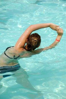 Girl in pool doing aerobic