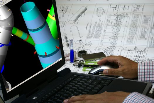 Mechanical engineer designing a pressure vessel. Note 3d display in the monitor is my original works.