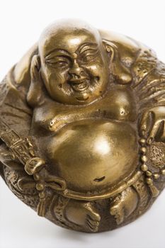 Happy laughing Buddha brass figurine on white background.