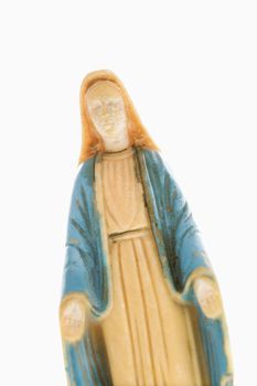 Virgin Mary statue with hands held out against white background.