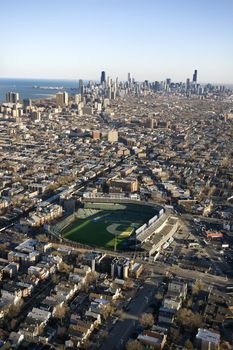 Aerial view of Wrigley Field with Chicago, Illinois skyline in background.