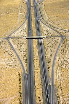 Aerial view of desert highway with overpass.