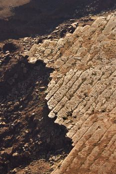 Aerial of deteriorating rock cliff in high desert of Utah, USA.