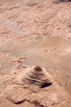 Aerial of extruding rock formation in desert landscape of Utah, USA.