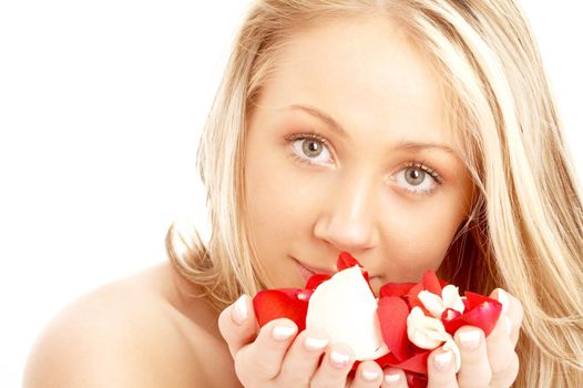 portrait of happy blond in spa with red and white rose petals