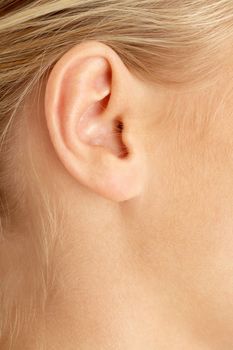 color closeup picture of blond girl ear