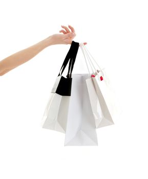 hand with three shopping bags over white