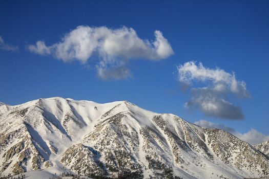 Aerial landscape of snow covered mountain peaks in California, USA.