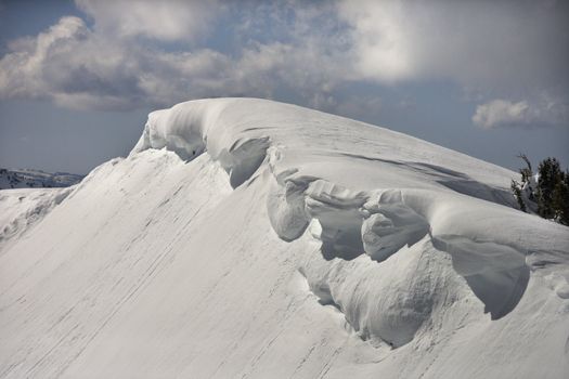 Aerial of snowcapped mountain peak in Crystal Mountains, California, USA.