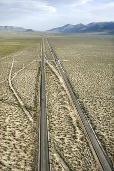Aerial of desolate scenic highway through rural desert landscape of California, USA.