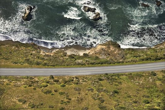 Aerial of coastal scenic highway along Pacific Ocean on California west coast, USA.