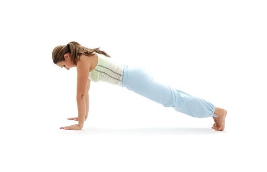 sporty girl practicing chaturanga dandasana four-limbed staff pose