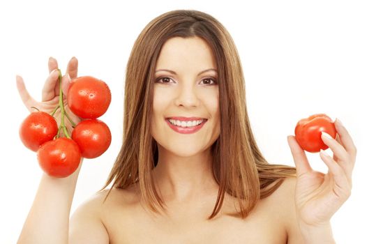 beautiful brunette girl holding tomatos over white