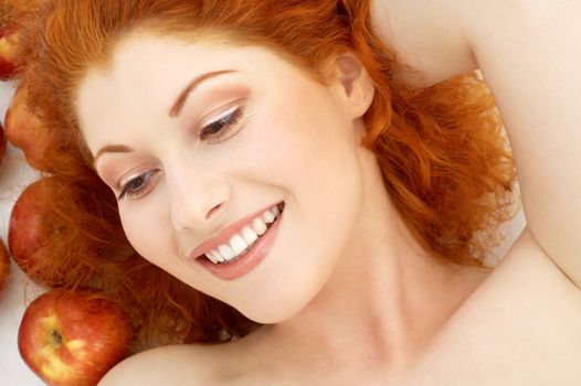 picture of lovely redhead with red apples