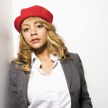 Portrait of pretty woman standing against white background.