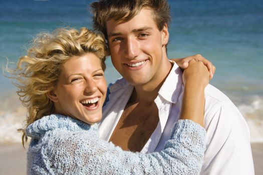 Happy smiling couple embracing on Maui, Hawaii beach.