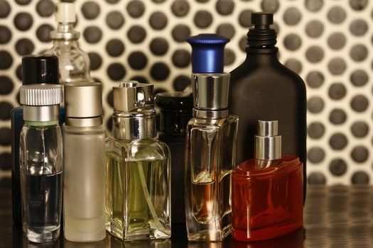 Set of perfume bottles in a black tiles background