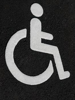 White wheelchair disabled sign on the road